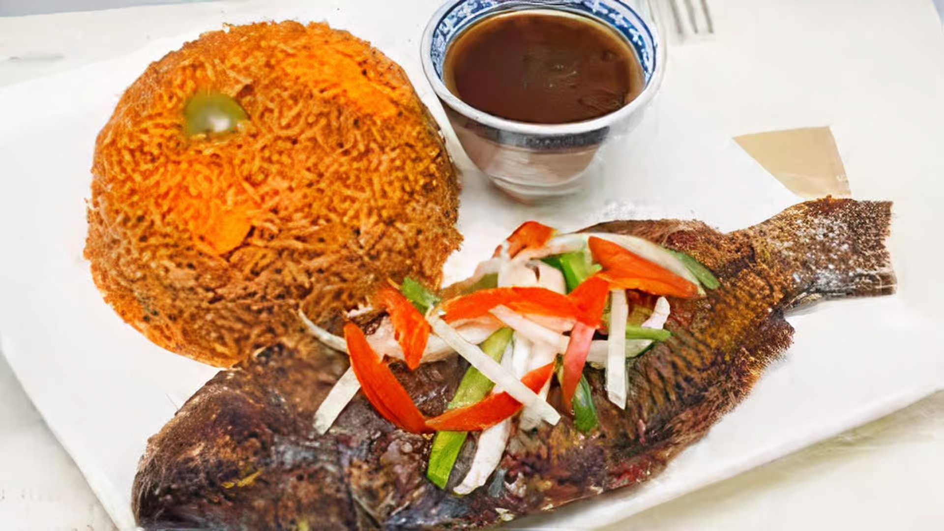 Jollof Rice with Tilapia Fish - West African jollof rice served with perfectly seasoned grilled tilapia fish